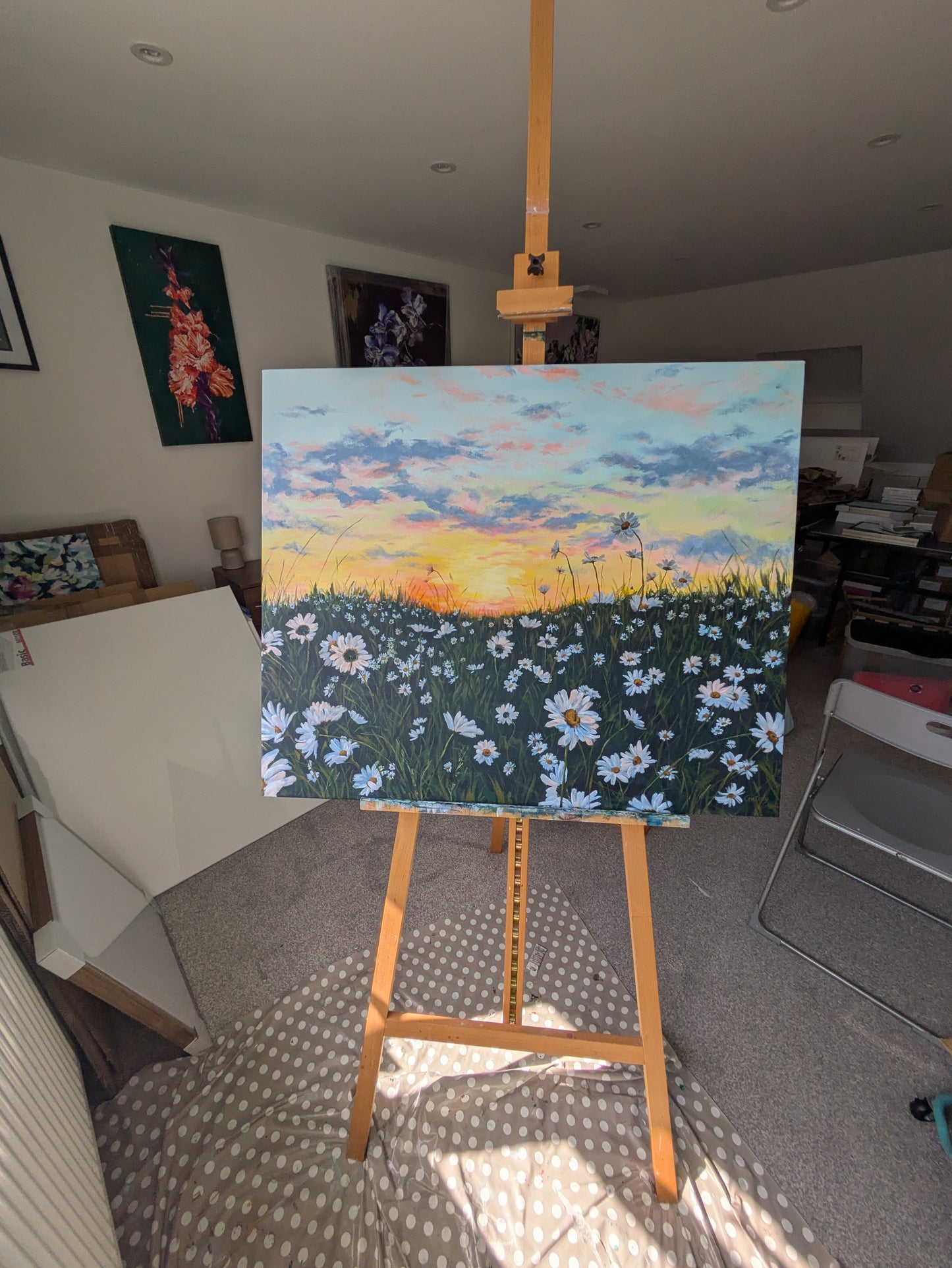 Large daisy sunset landscape painting in Judy Century Art Studio, fresh on the easel