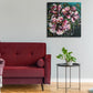 Abstract Floral Wall Art by Judy Century. Vibrant, expressive flower painting in pinks, greens and blues. Home Decor ideas - painting shown on grey wall next to red sofa and above a black coffee table with plant.