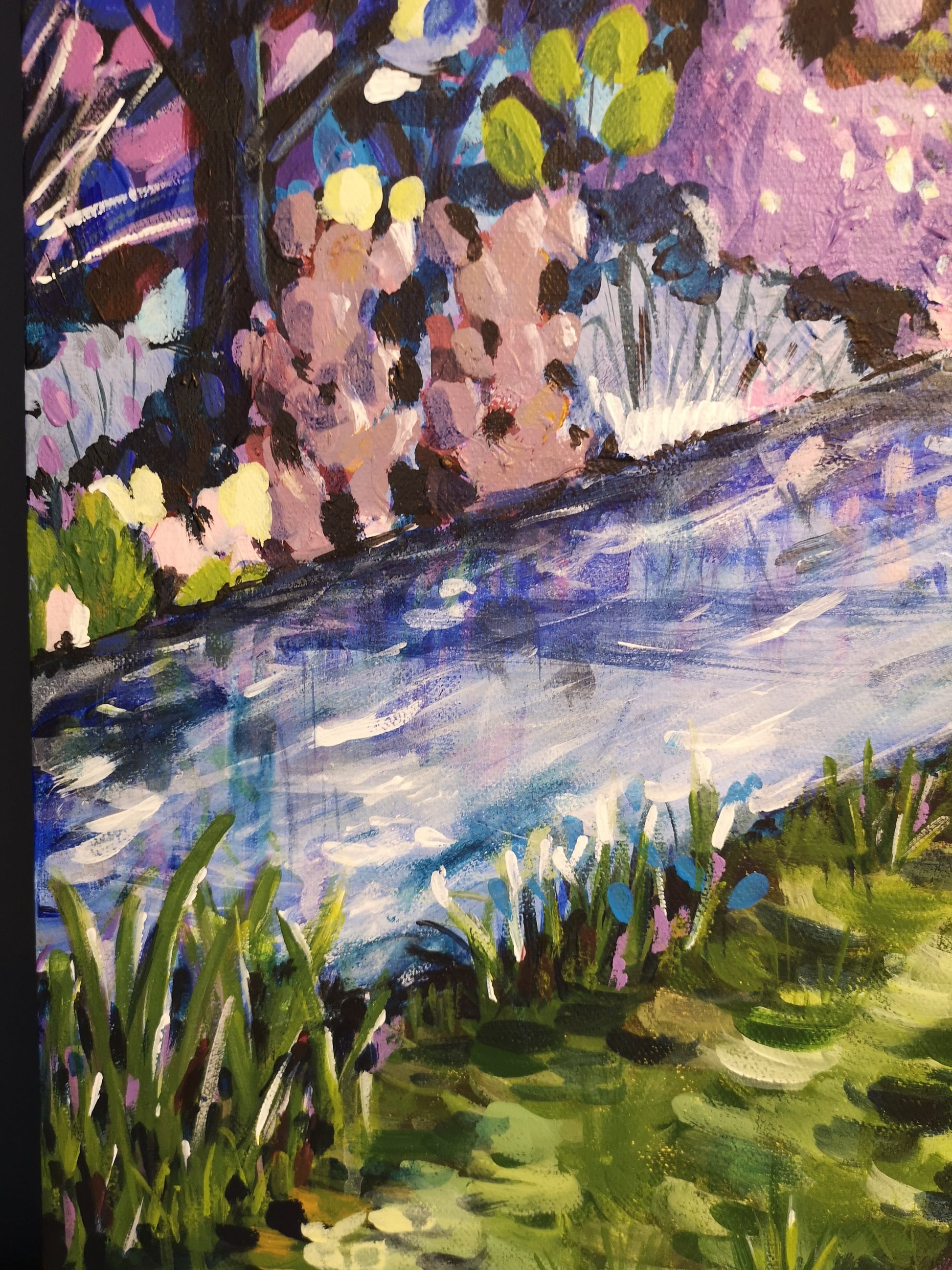 Close up of abstract landscape painting by Judy Century Art featuring stylised trees and bushes and flowing river in multicolour.