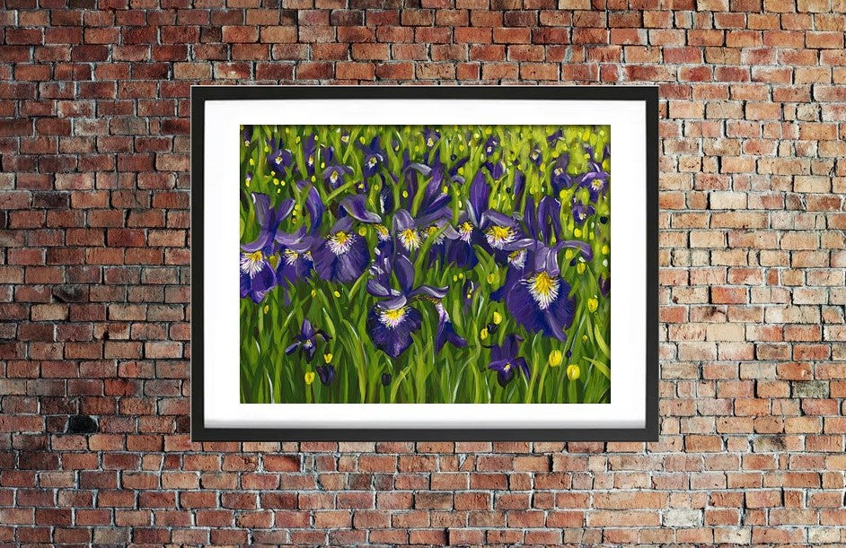 Iris landscape acrylic painting in expressive style. Bold purple, yellow, white, green with leaves and flowers. Framed in black by Judy Century Art. Shown hanging on a red brick wall