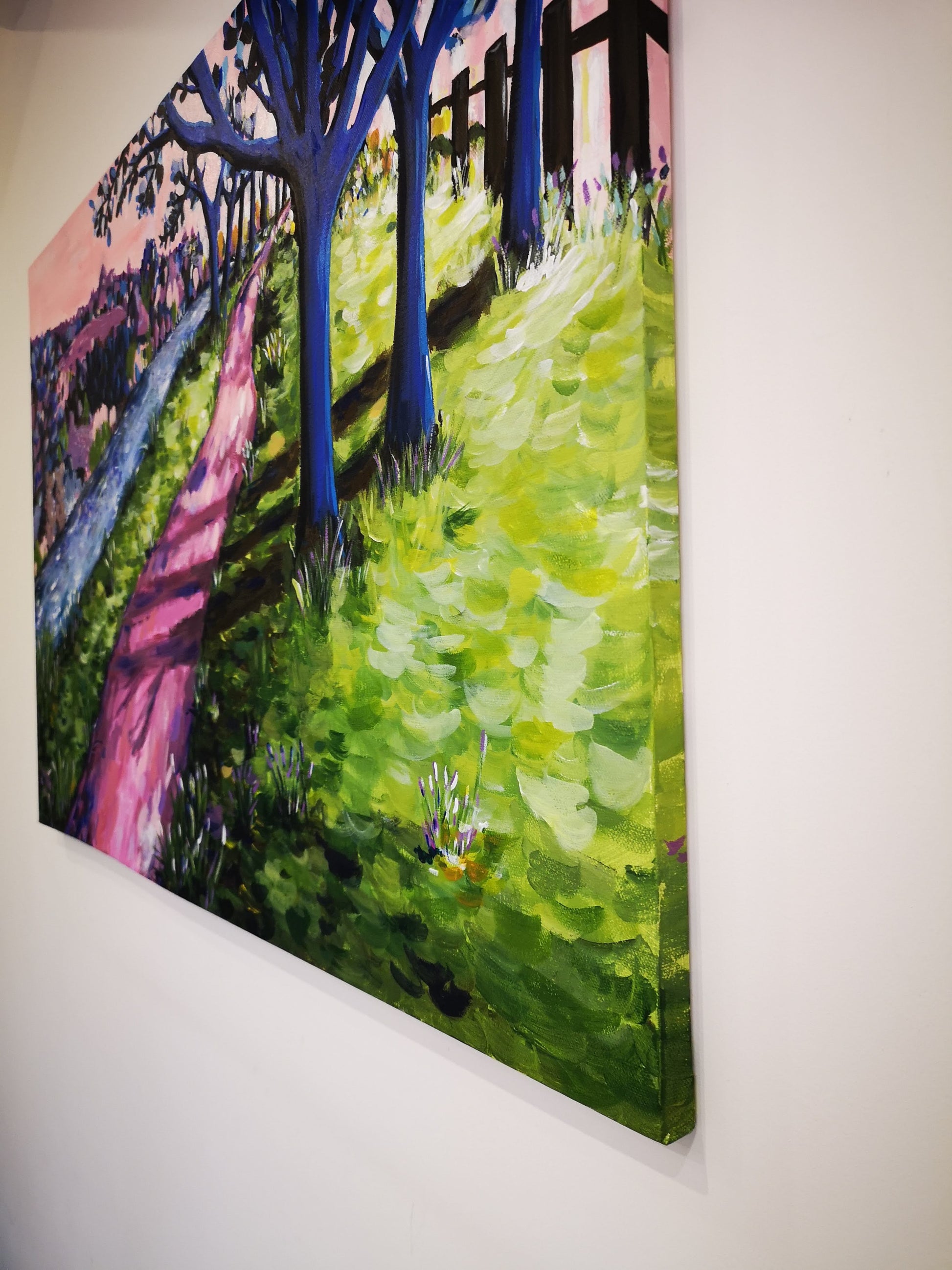 Colourful abstract landscape of an enchanting woodland scene with a shady path, trees, a river and colourful abstract bushes. Photo illustrating painting wrapped around the canvas edge.Acrylic painting by Judy Century Art.