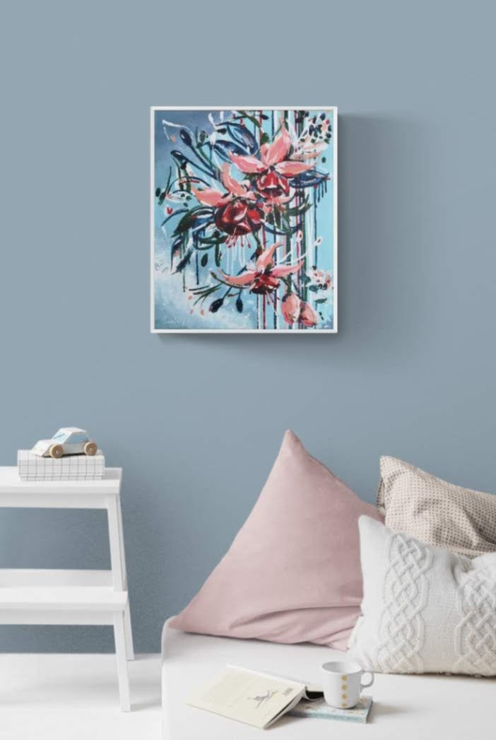 Abstract contemporary floral wall art canvas by Judy Century Art. Falling Fuscia flowers in pink and peach against a light blue background. Shown in a kids bedroom with car toy and day bed with cushions
