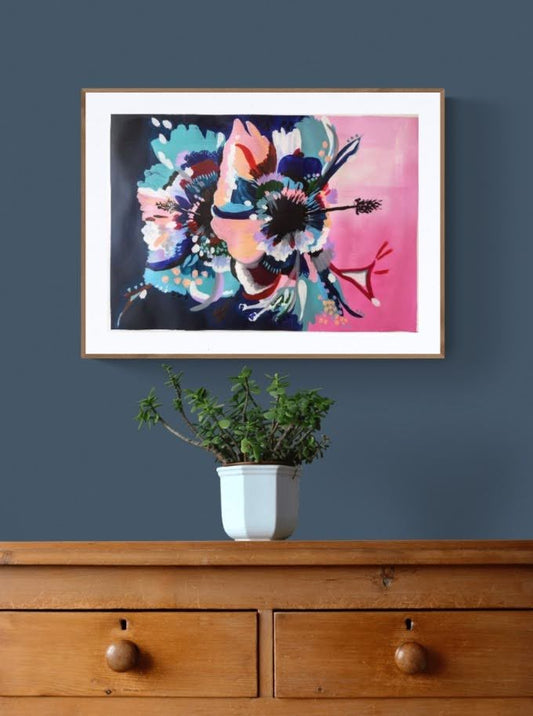 Art Print of original Hibiscus Flower abstract painting by Judy Century Art. Framed in wooden frame, hanging over a wooden chest of drawers on a navy wall.