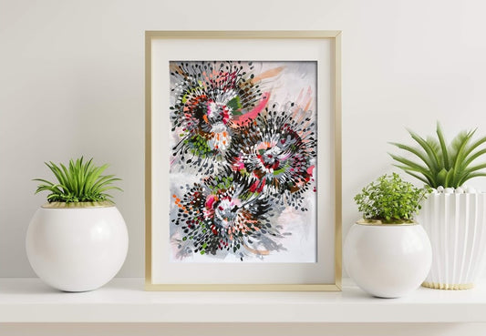 Original Acrylic painting on paper by Judy Century Art. Inspired by flowers, this painting is full of movement and energy, called spokes and spikes. Featuring grey, green, pink, black, brown, peach and white. Gold frame sitting on white shelf with green plants.
