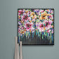 Colourful Floral Canvas painting of abstract flower bouquet by Judy Century. Home decor ideas shown above wooden console table on teal duck egg blue wall with silver vase ornaments