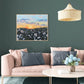 Large floral landscape painting in living room with pink sofa and green walls. Canvas art with wild daisies and sunset sky.