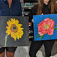 Colourful flower canvas paintings proudly shown off by painting workshop attendees from Judy Century Art Paint class