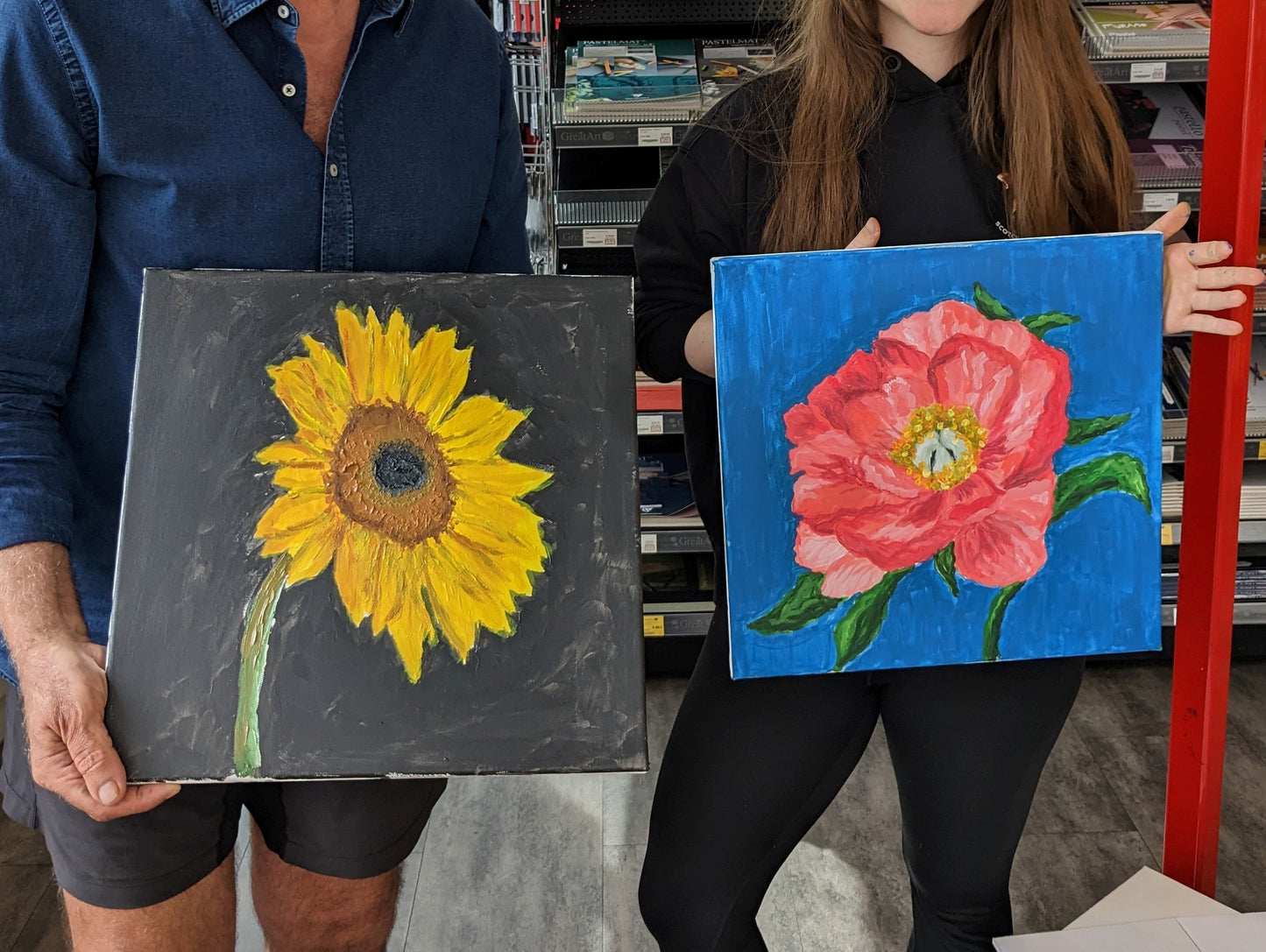 Colourful flower canvas paintings proudly shown off by painting workshop attendees from Judy Century Art Paint class