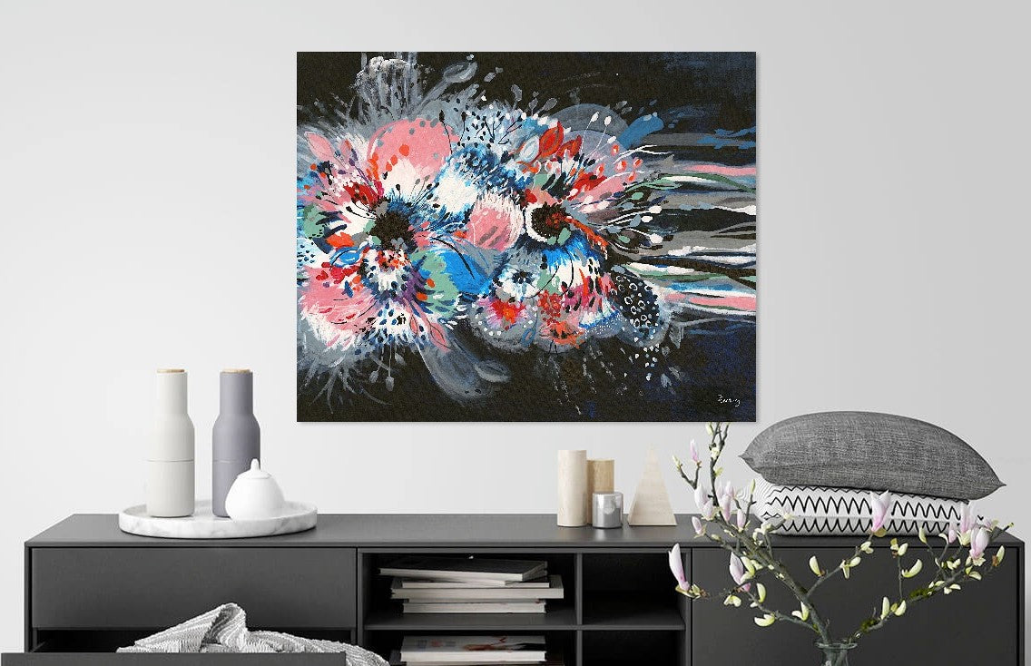Art print of Large Abstract acrylic painting of Hibiscus flower by Judy Century Art. Bold, bright colours, of blue, pink, green, white, green and navy with expressive lines flowing out. Canvas print featured in situ hanging above grey sideboard.