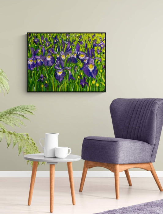 Iris landscape acrylic painting in expressive style. Bold purple, yellow, white, green with leaves and flowers. Framed in black by Judy Century Art. Shown hanging magnolia wall framed in black with purple occasional chair.