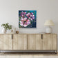 Abstract Floral Wall Art by Judy Century. Vibrant, expressive flower painting in pinks, greens and blues. Interior decor inspiration hanging on white wall above wooden sideboard.