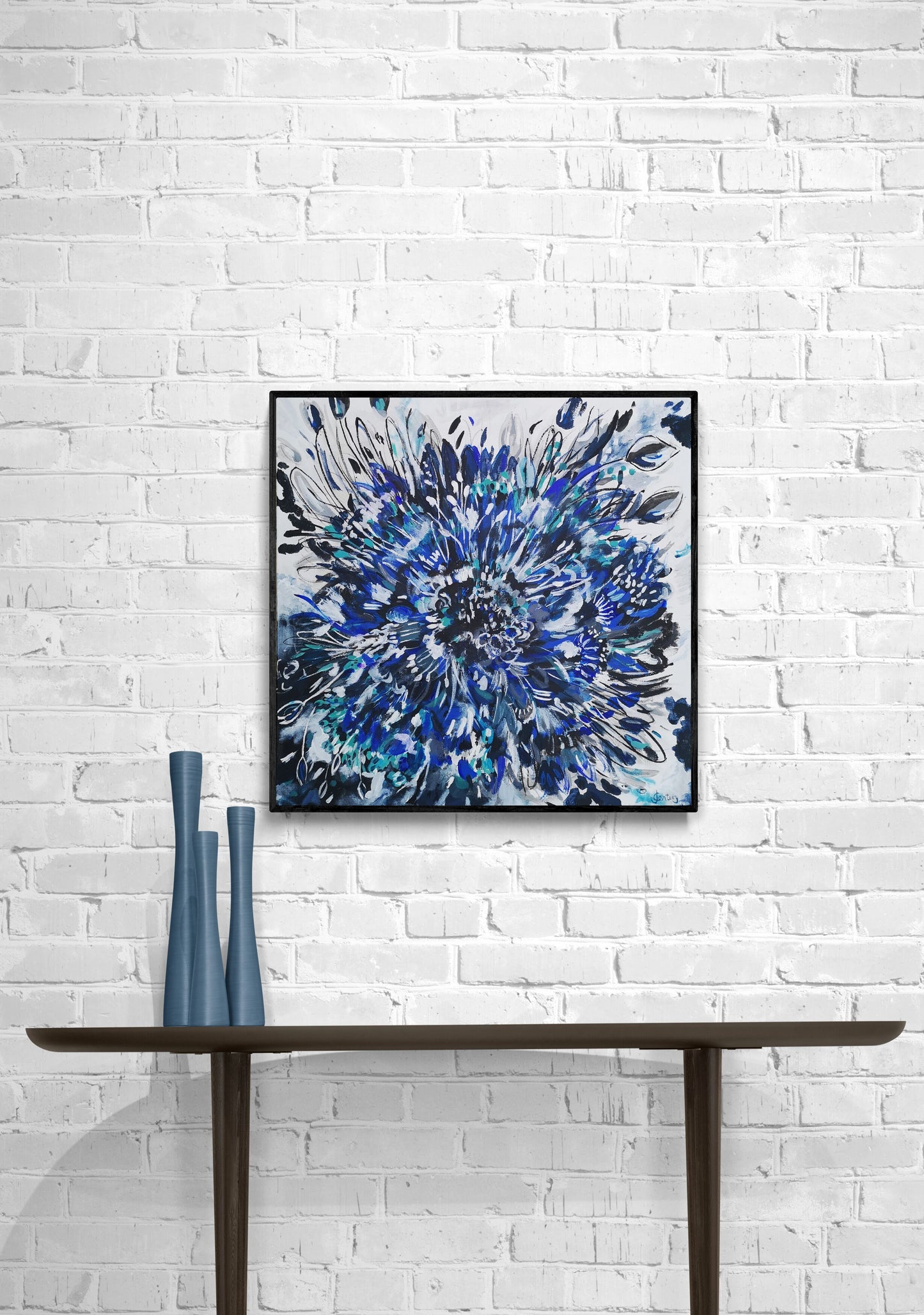 Abstract flower wall art in situ hanging against white brick wall blue cornflower burst canvas by Judy Century