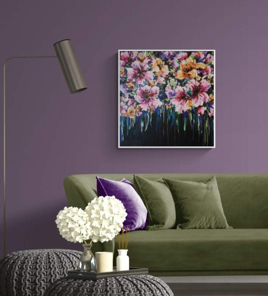 Colourful Floral Canvas painting of abstract flower bouquet by Judy Century. Shown hanging on warm purple wall above olive velvet sofa with home accessories