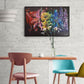 Multi-coloured abstract Carnival Rainbow flower painting on contrasting black background by Judy Century Art.  home decor inspiration wall art shown on white brick wall above wooden dining table with colourful blue, mustard yellow and blush pink chairs