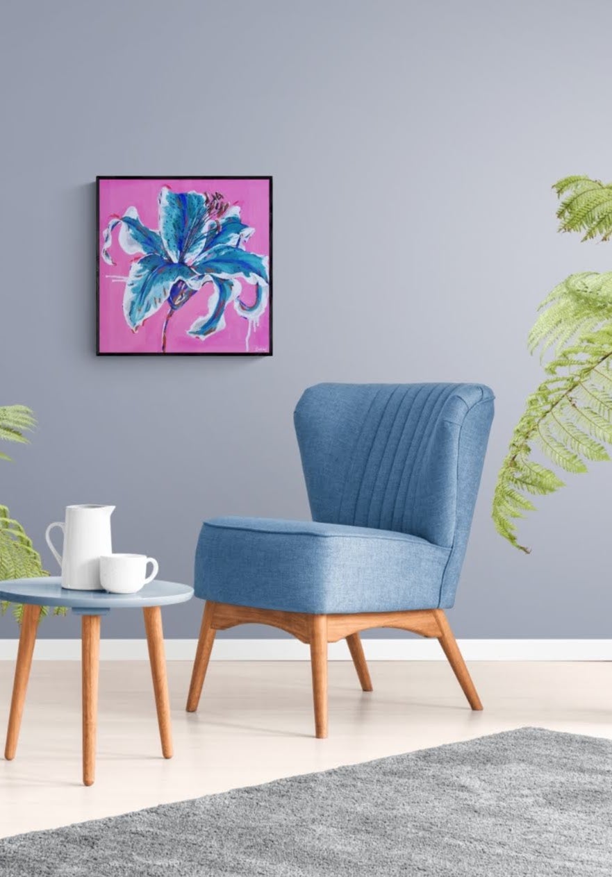 Flourish, abstract flower wall art by Judy Century. Pop Art Style Lily shown hanging in a living space next to blue chair. Interior design Inspiration