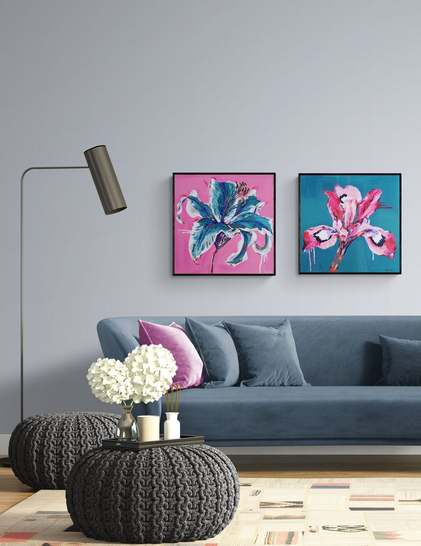Pair of colourful abstract floral paintings by Judy Century hanging in contemporary living room above navy couch
