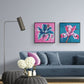 Pair of colourful abstract floral paintings by Judy Century hanging in contemporary living room above navy couch