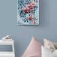 Abstract contemporary floral wall art canvas by Judy Century Art. Falling Fuscia flowers in pink and peach against a light blue background. Shown in a kids bedroom with car toy and day bed with cushions