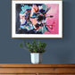 Art Print of original Hibiscus Flower abstract painting by Judy Century Art. Framed in wooden frame, hanging over a wooden chest of drawers on a navy wall.