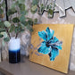 Contemporary original gold and turquoise blue painting of hibiscus flower by Judy Century Art displayed in hallway table