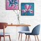 Pair of contemporary flower paintings on canvas by Judy Century, hanging in a dining room with white brick walls