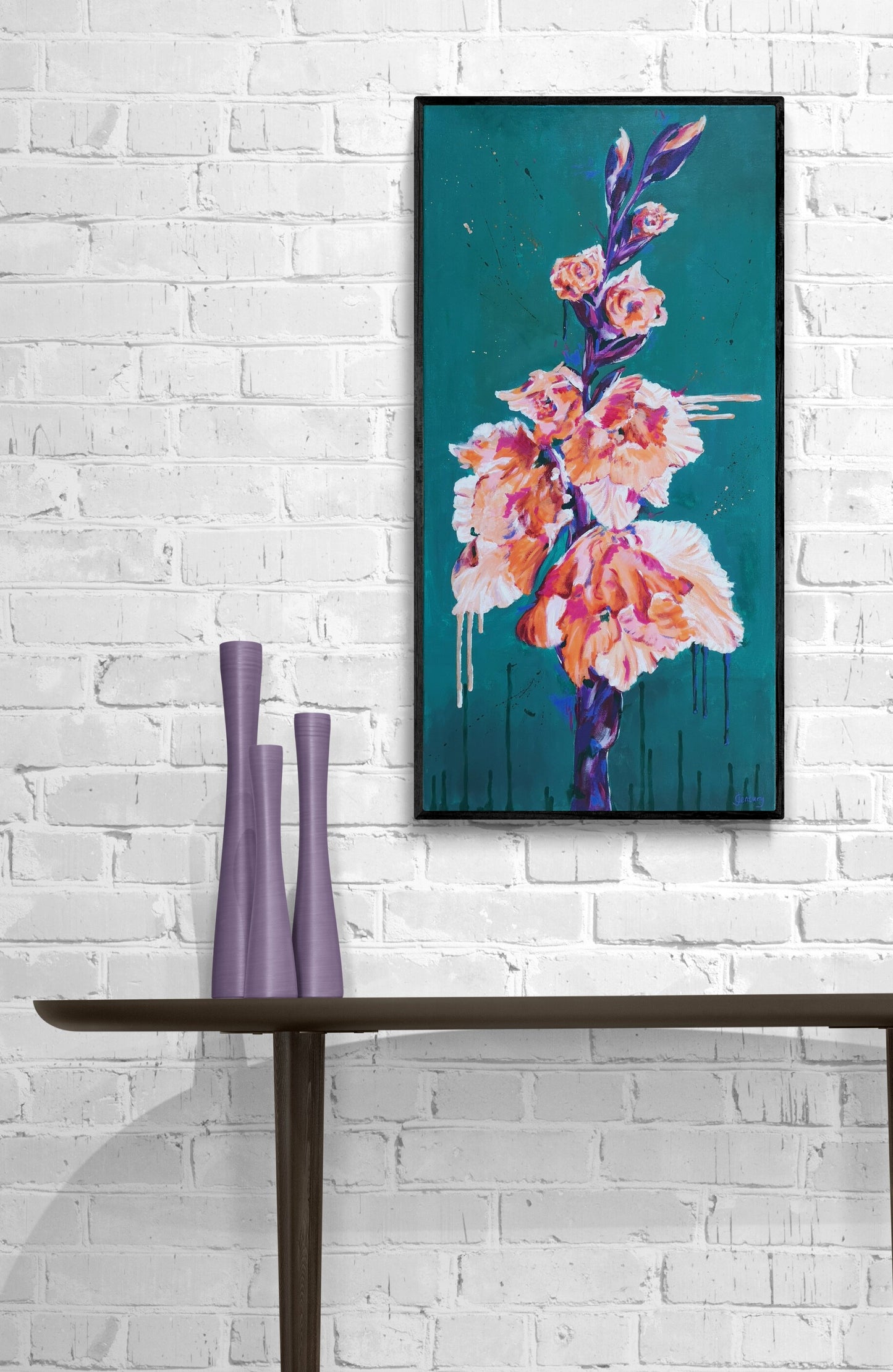 Contemporary floral painting in orange and deep green by Judy Century Art. Hanging on white brick wall above wooden console table.