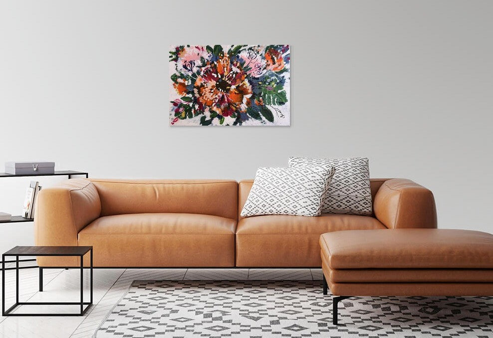 Abstract original acrylic painting by Judy Century art. 'Tropical Garden' features cheese plants, bright orange, magenta and gold flowers and floral inspired shapes. Hanging above a tan leather couch with grey and white cushions.