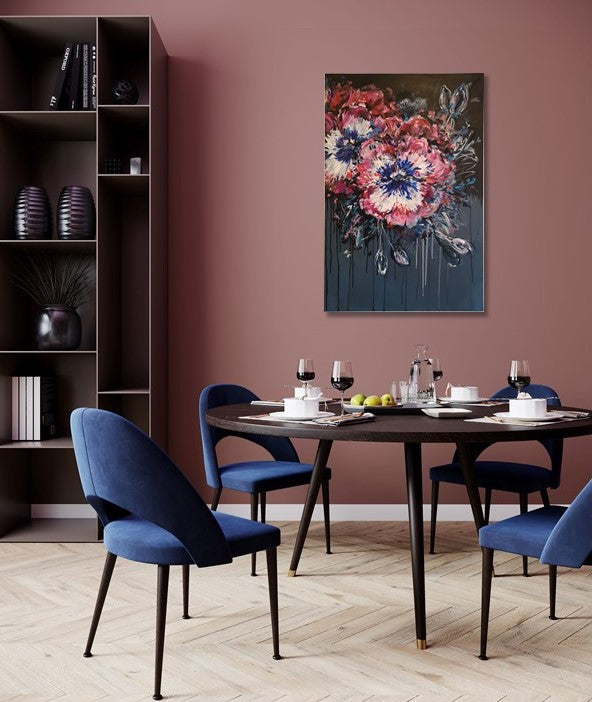 Contemporary Abstract Floral Pansy painting on dark background by Judy Century Art hanging on raspberry coloured wall in dining room with blue chairs